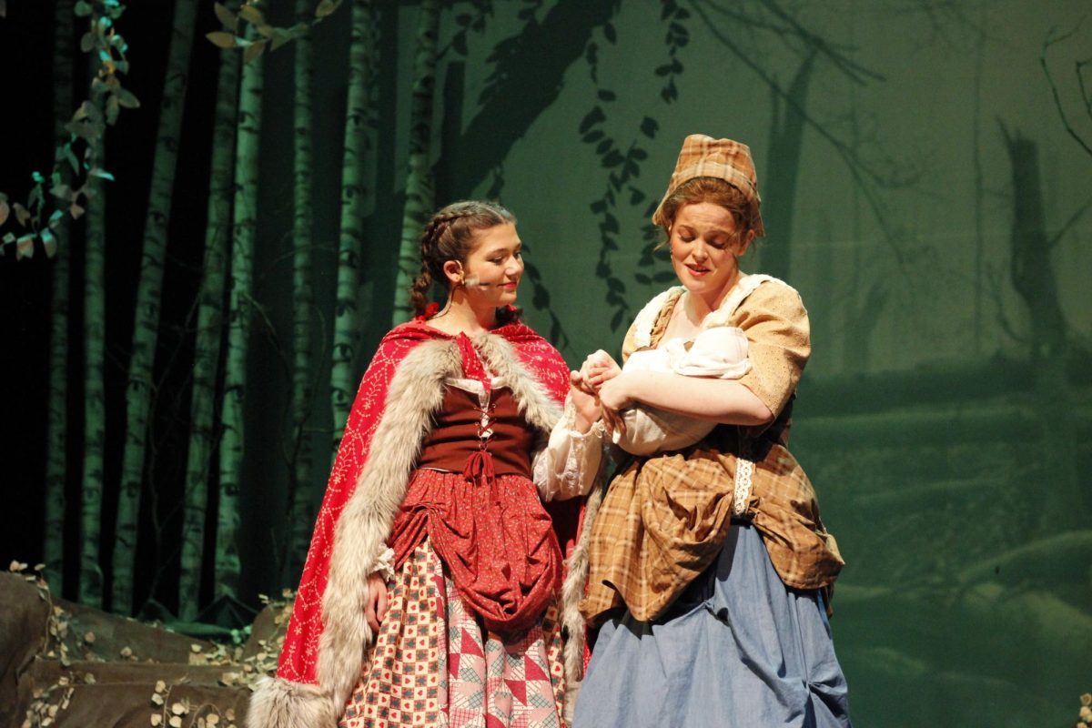 Little Red Riding Hood (Karoline Maloy) and Cinderella (Aderyn Ketchum) looking after the Bakers baby.