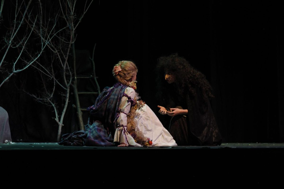 The Witch (Parker Cropp) lectures Rapunzel (Lily Hasselbach).