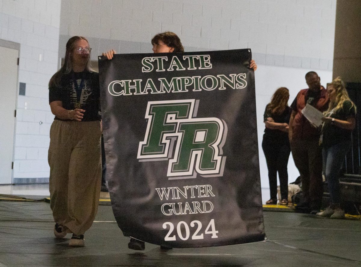Marching Band and Winter Guard unveil their 2024 state championship banners.