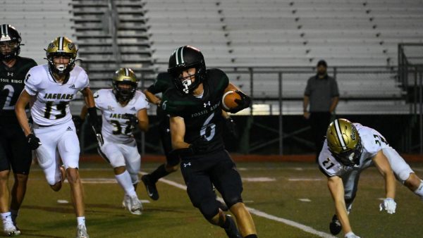 Harley Schmidt runs past Rock Canyon’s defense after a kickoff.