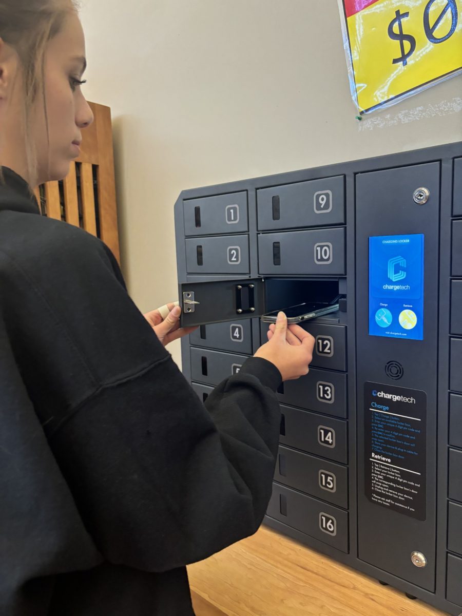 Findlay West puts her phone in the phone charger box.