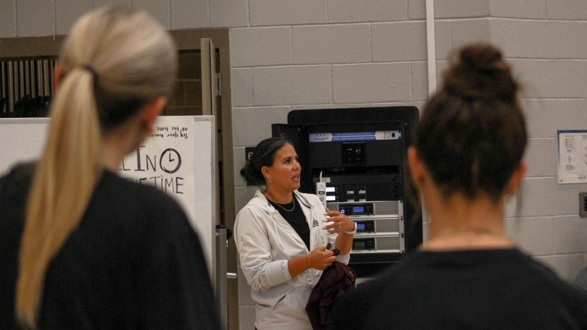 Coach Natalie Burton addresses the Varsity and JV teams during practice on Wednesday, October 16.