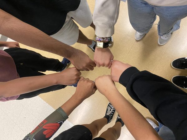 Students Melany Parra Lopez, Sandra Rodriguez, Zamira Hernandez Calvo, Loni Jackson, Easton Brewer and Jacob Enzo Lorenzana, touch fists to show unity. 