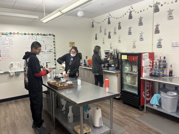 Cup of Joe workers Andre Chavez, Vandana Kothari and Avalyn Hoglin making drinks during the morning rush on December 5th. 