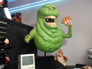 Replica of Slimer from Ghostbusters eating a slice of pizza