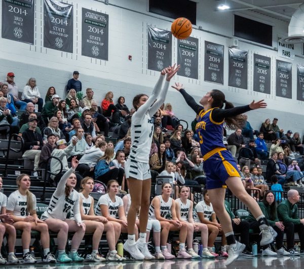 Lauren Smith shoots a three pointer with a defender in her face on Wednesday night against Denver North in play-in game.