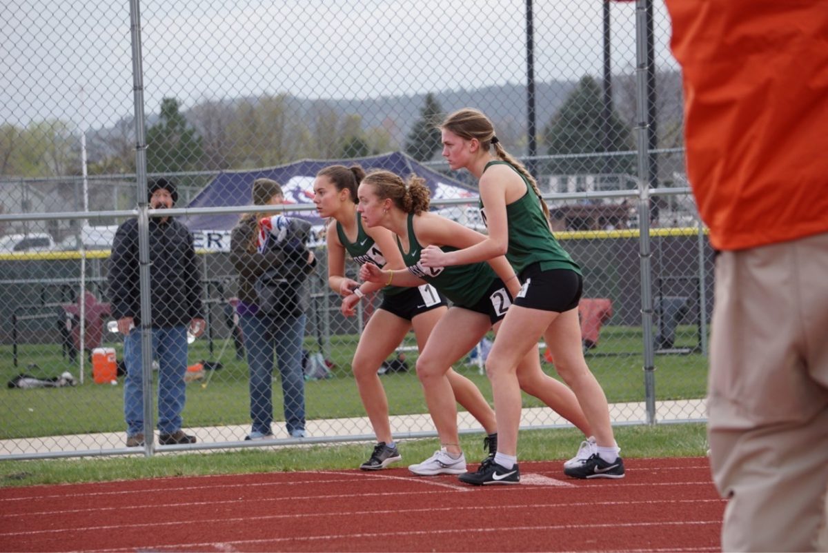Standing on the line, runners Lisie Malzahn (left), Diana Hunt, and Oakley Pringle get ready to race in the girls 800m event.