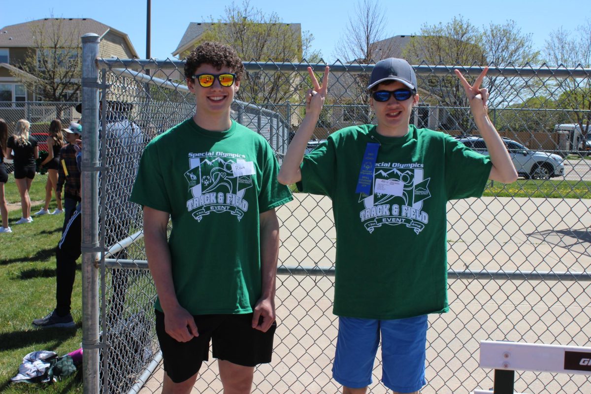Athlete Oscar Centeno and peer buddy Ryan Rieker pose for a photo.