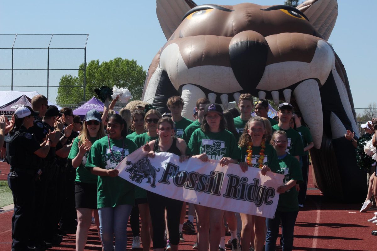 Fossil athletes walk in the Parade of Teams during the Special Olympics.