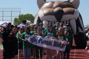 Fossil athletes walk in the Parade of Teams during the Special Olympics.