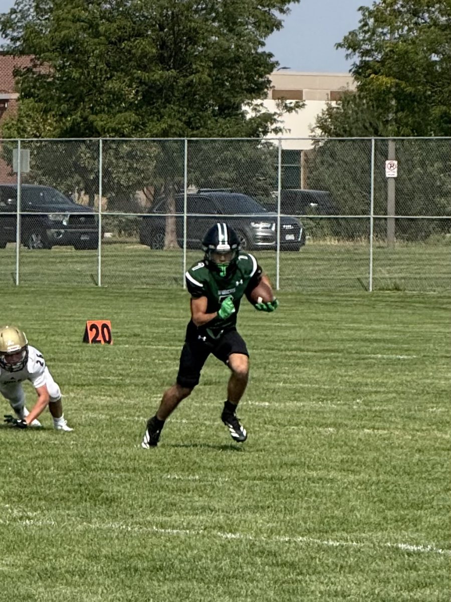 Ray Young takes the football and jukes out defenders at Fossil practice field in early September.
