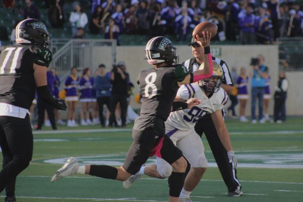 Quarterback and junior Nick Kubat throws to teammate(2023).