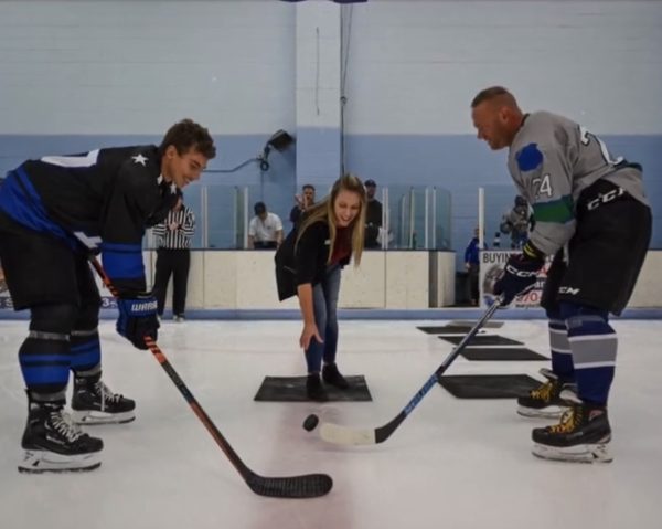Officer Adams Brunjes and a PSD Stars hockey player facing off at a Kids vs. Cops Hockey Game in 2023.

