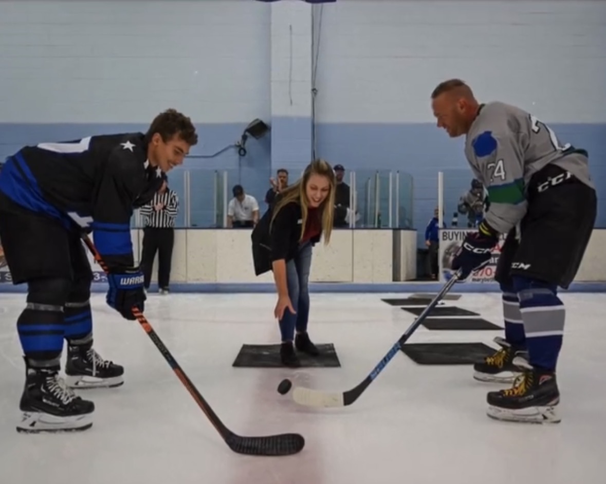 Officer Adams Brunjes and a PSD Stars hockey player facing off at a Kids vs. Cops Hockey Game in 2023.
