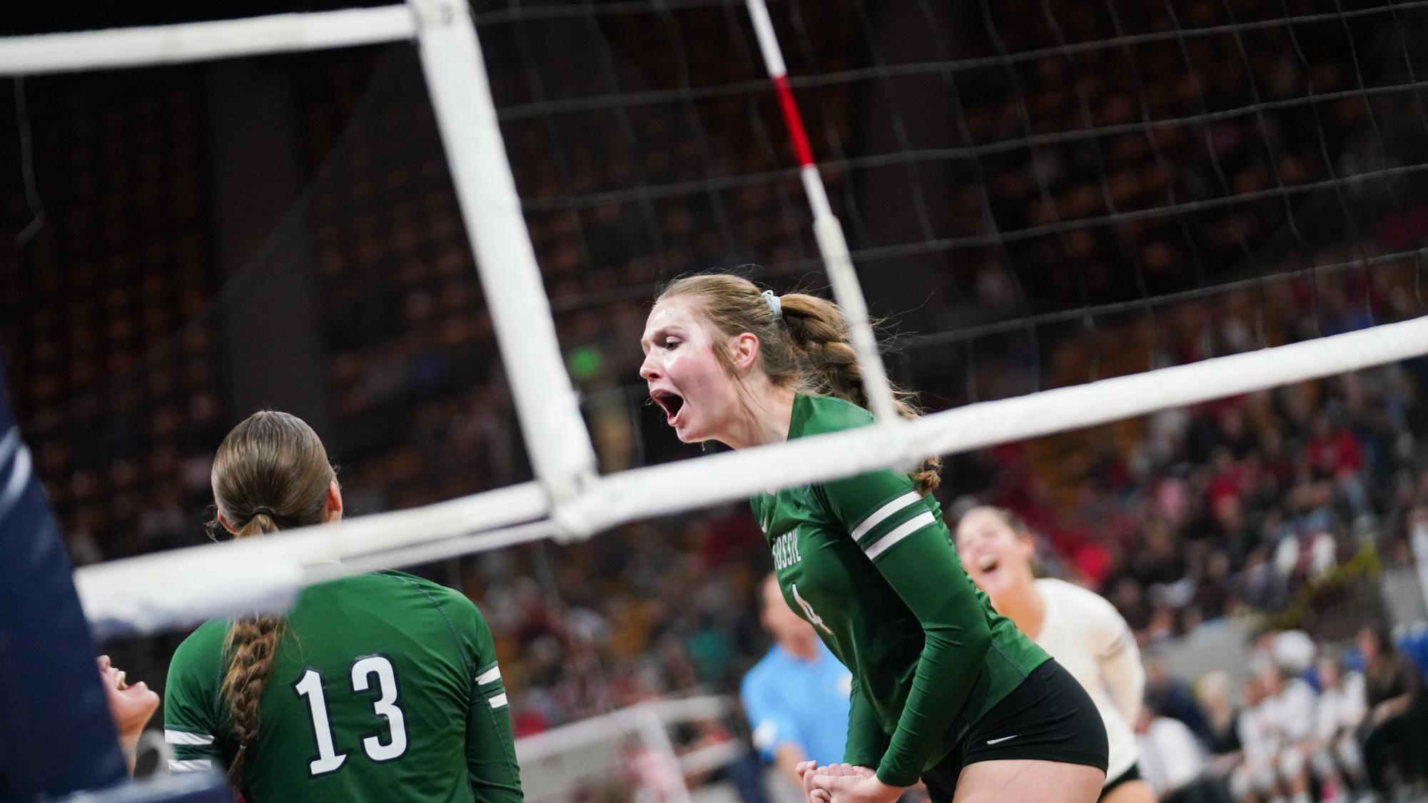 Junior Ella Wilson middle hitter celebrating after a play.