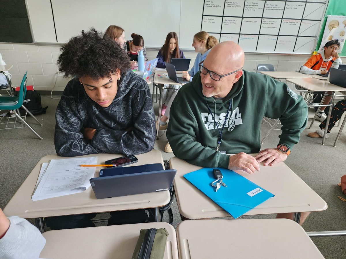 In-house substitute Steve Odell (right) talks to junior Sam Jones (left). 
