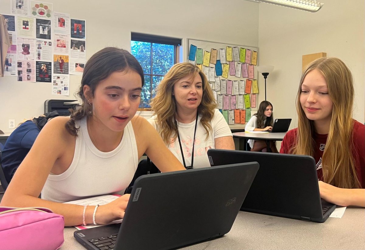 Fossil teacher Sarah Socolofsky (middle) talks to Samantha Lockwood (left) and Emily Richardson (right) during her fourth period interior design class.
