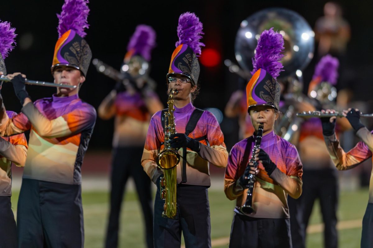 Thomas Bean (left) Julius McIver (middle) and Emmy Yuan (right) perform at the state championship at the Air Force Academy in October. 
