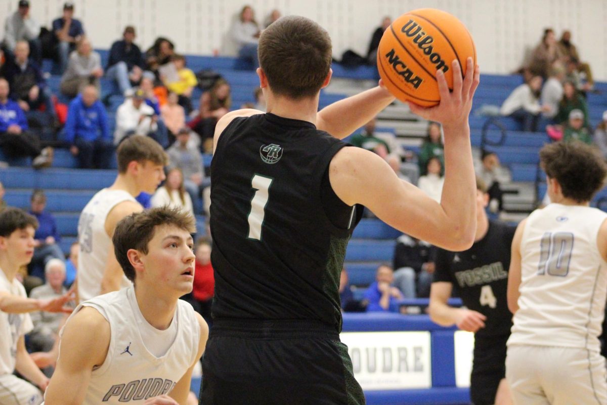 Jaimeson Peterson looks to pass the ball to a teammate on January 23, 2026 at Poudre high school.