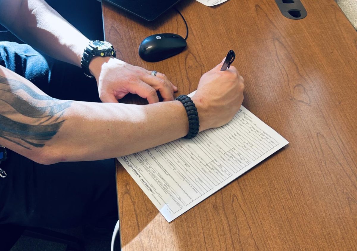Officer Adam writes MIP citation. 