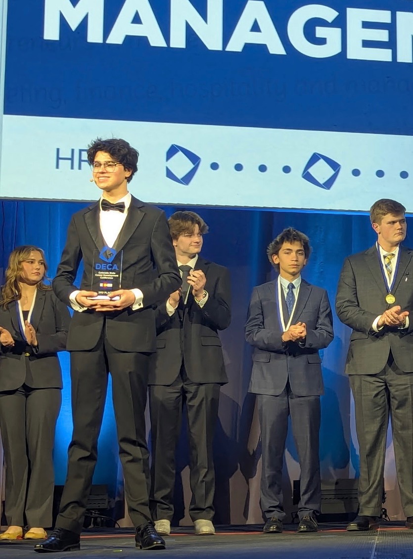 Fossil Ridge student Dawson Willey stands on stage during the closing ceremony honored as a finalist for his event at DECA stateon February 24, 2026 in Colorado Springs.