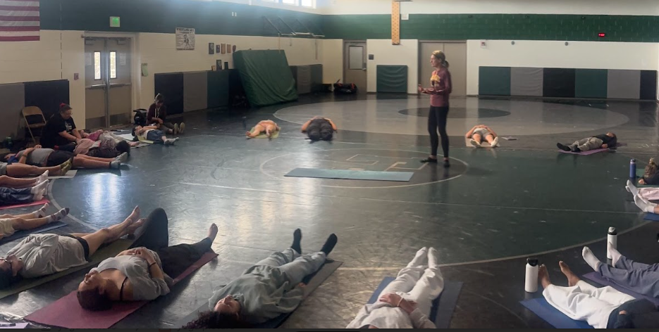 Mrs. Haanen leading student in a mindfulness activity during yoga class. 
