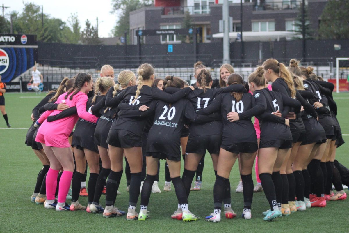 Fossil's Girls Soccer Team huddles up before their match. 